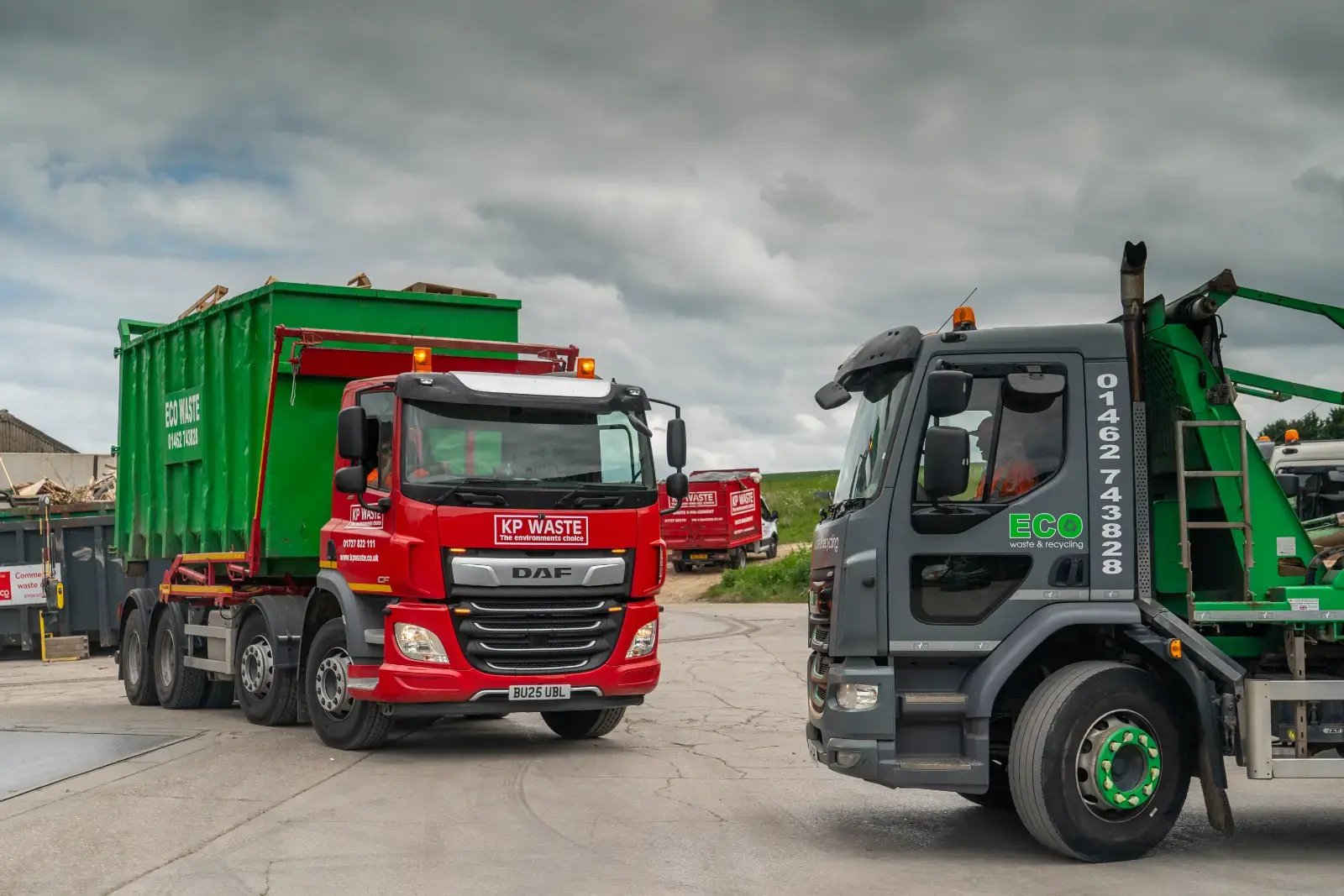 KP Waste and Eco Waste and Recycling trucks outside a CIRQLR subsidiary waste transfer station under a cloudy sky. Representing the group's integrated UK operating network.