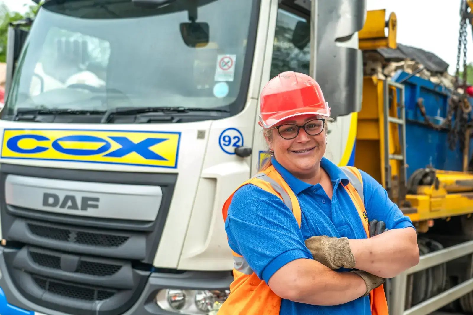 Cox Group employee standing beside a skip loader.