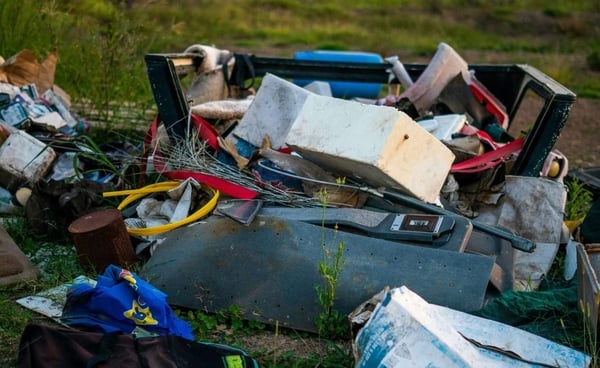 A pile of waste dumped in a field from fly tipping