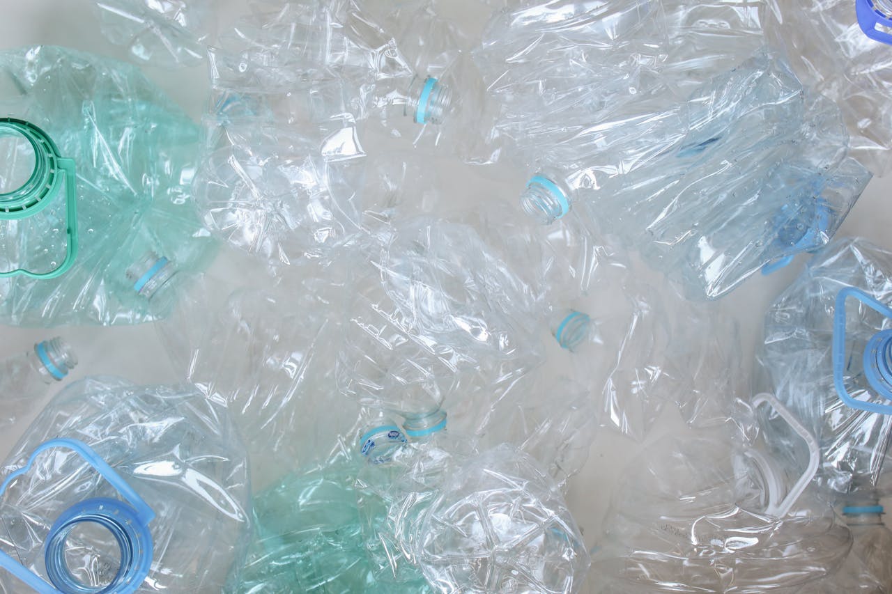 Pile of crushed clear plastic bottles prepared for recycling, symbolising plastic waste and environmental challenges in the UK